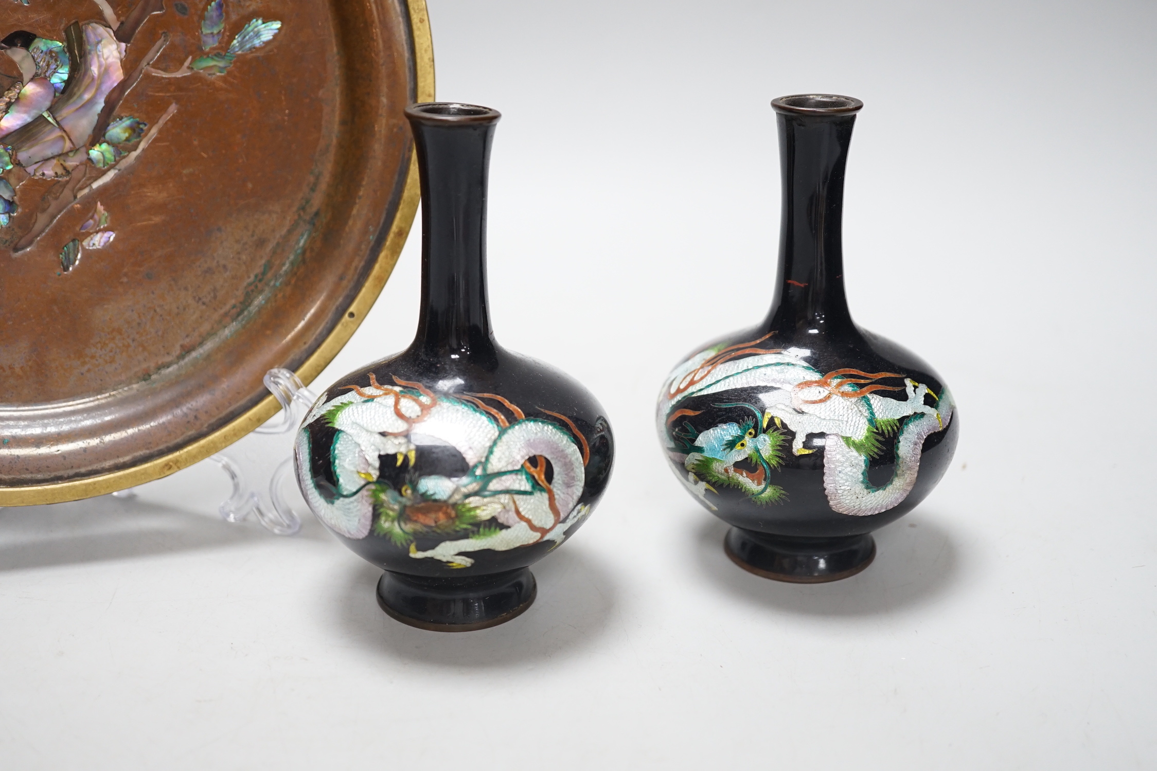 A Japanese bronze abalone inlaid dish and a pair of Japanese cloisonné vases enamelled with dragons, the dish 21cm in diameter